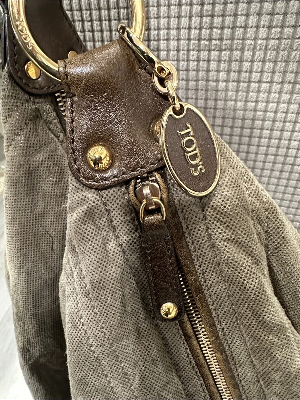 Tod’s Soft Metallic Taupe Hobo Bag with Gold Hardware. Lots of pockets,